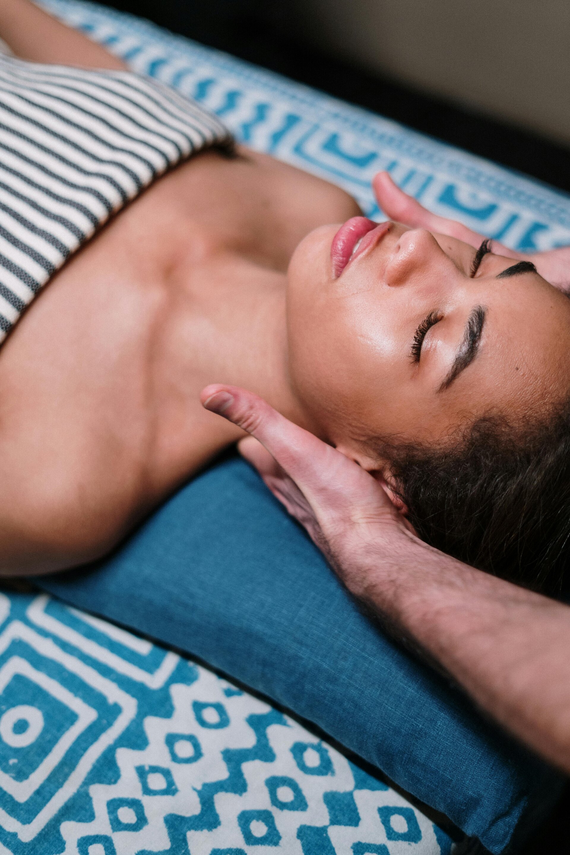 Peaceful spa massage therapy session - woman relaxing during wellness treatment